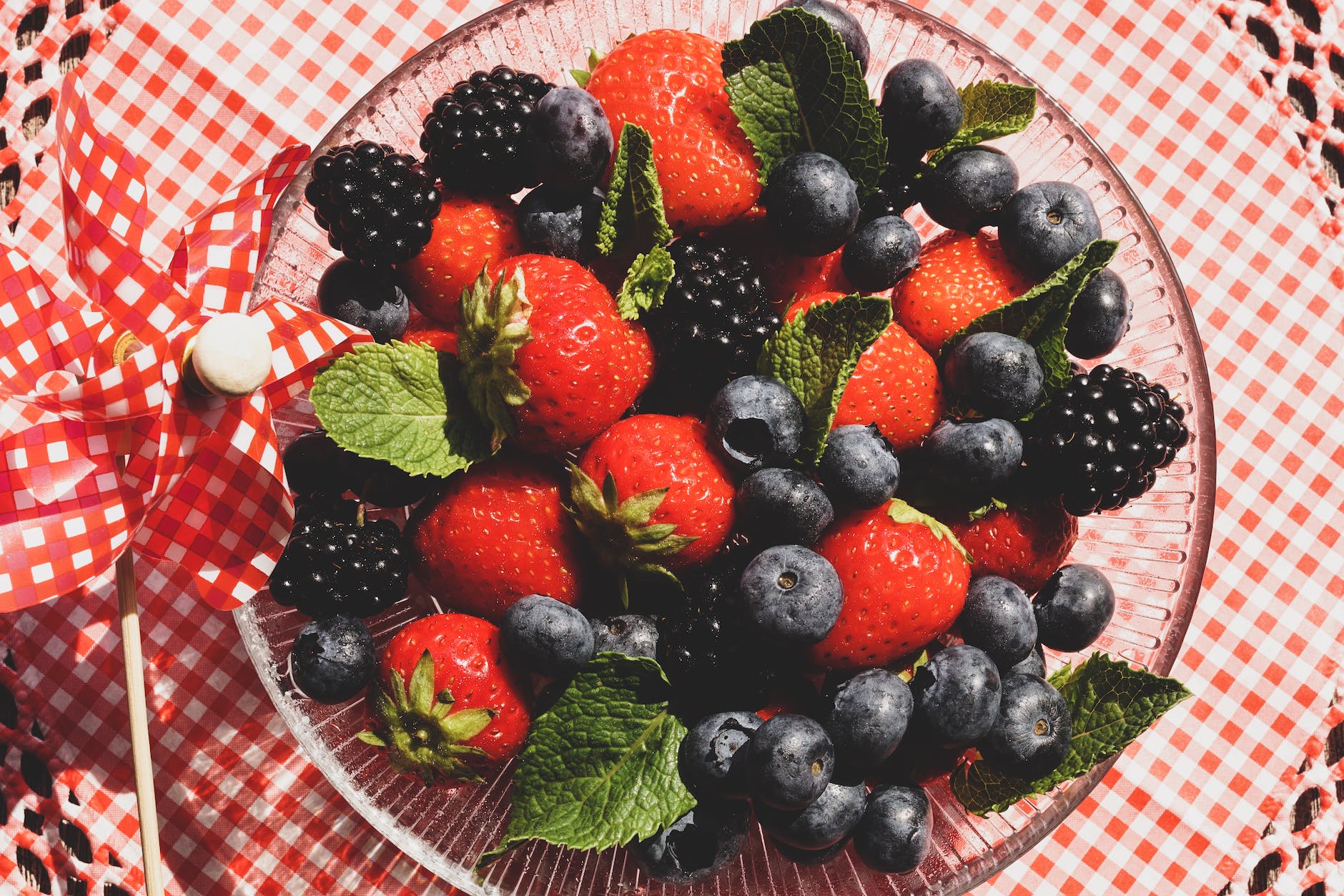 strawberries and blueberries on glass bowl