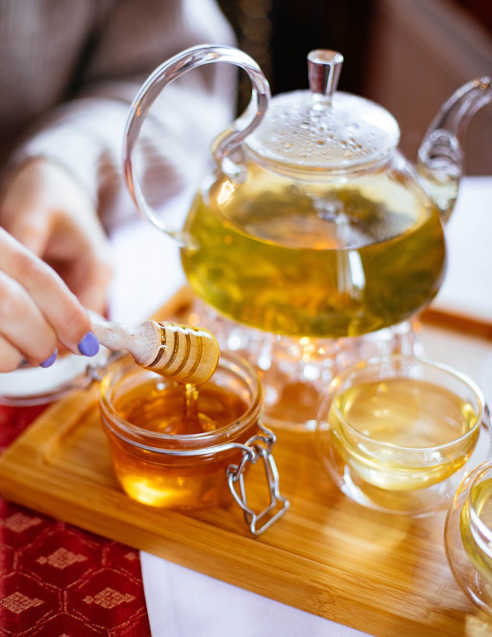 clear glass cup filled with honey