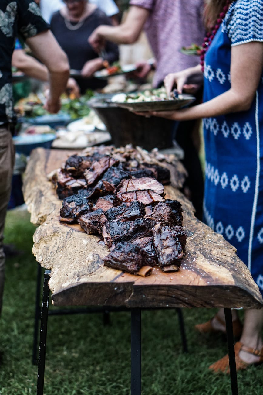 grilled meat laid on a wood slab