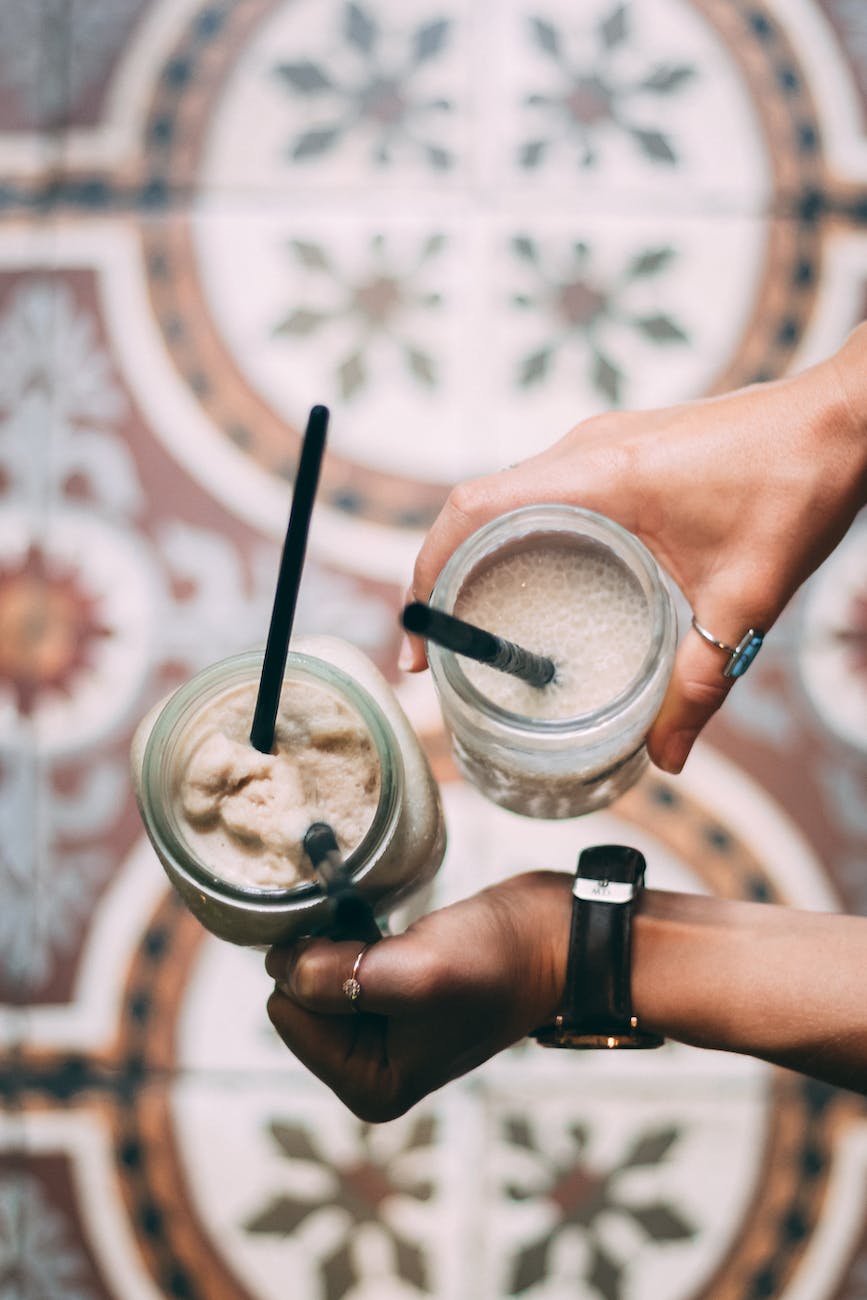 person holding clear plastic cup with ice cream