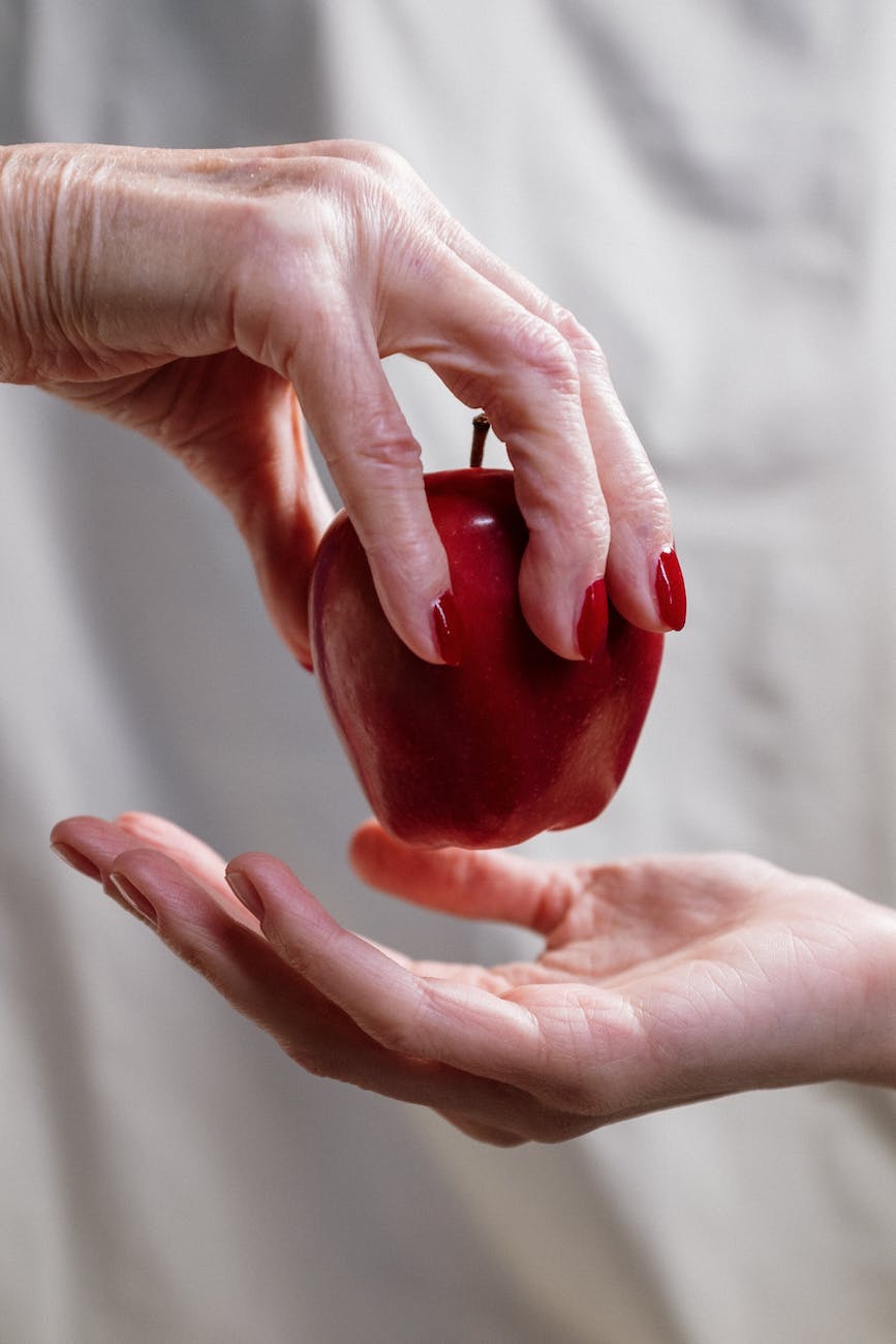 person holding red heart shaped ornament