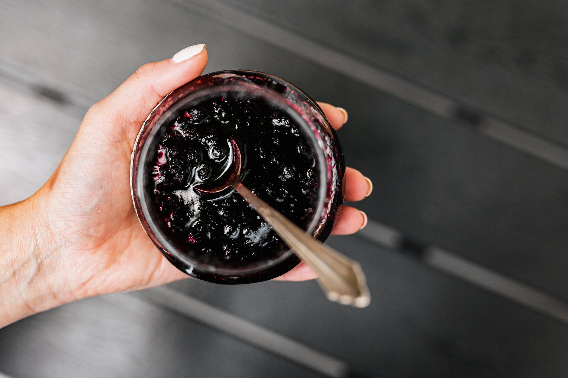 hand holding jar of delicious homemade jam