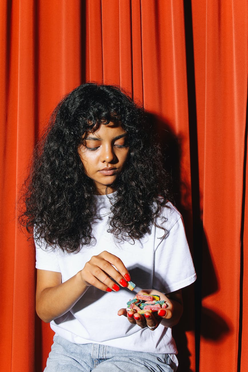 woman in white shirt holding candies