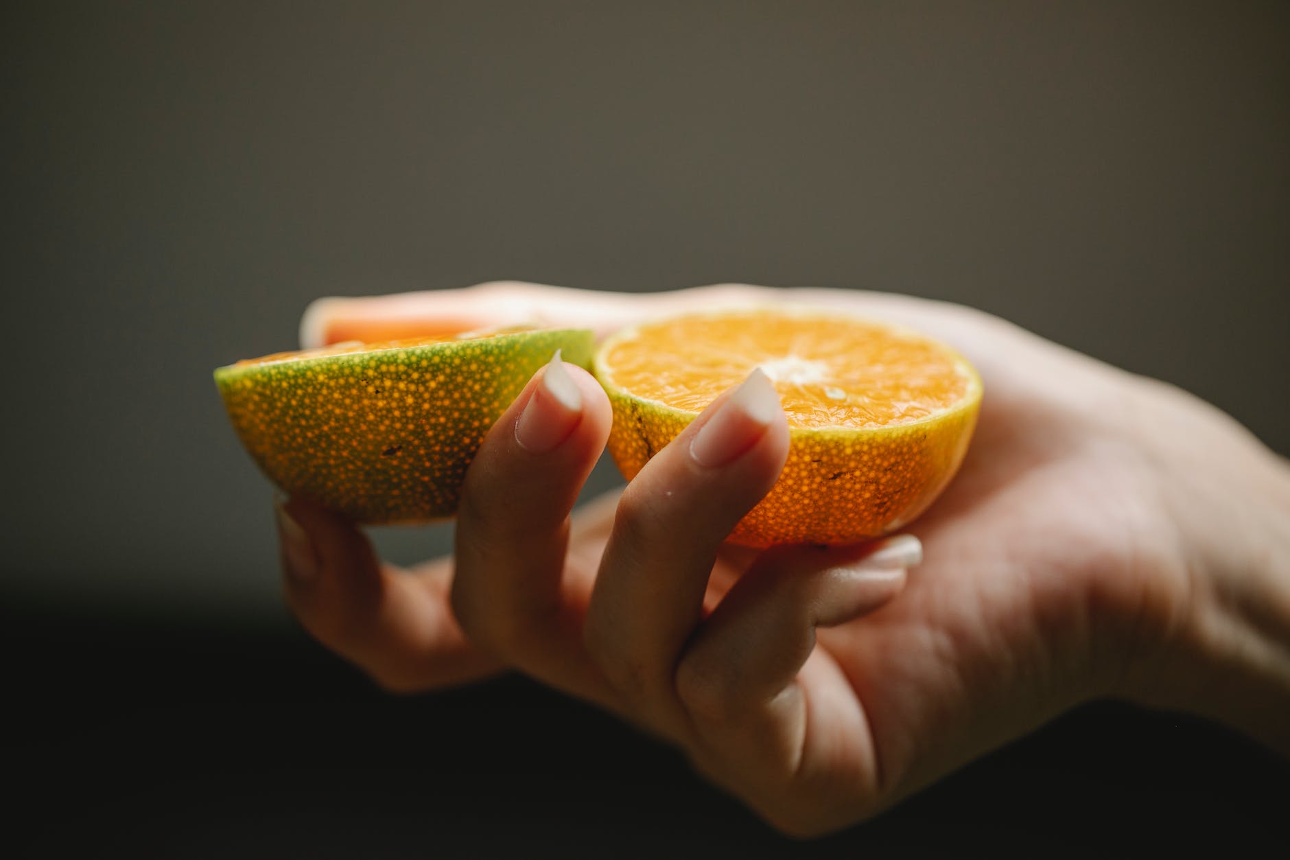 female with ripe juicy orange containing vitamins