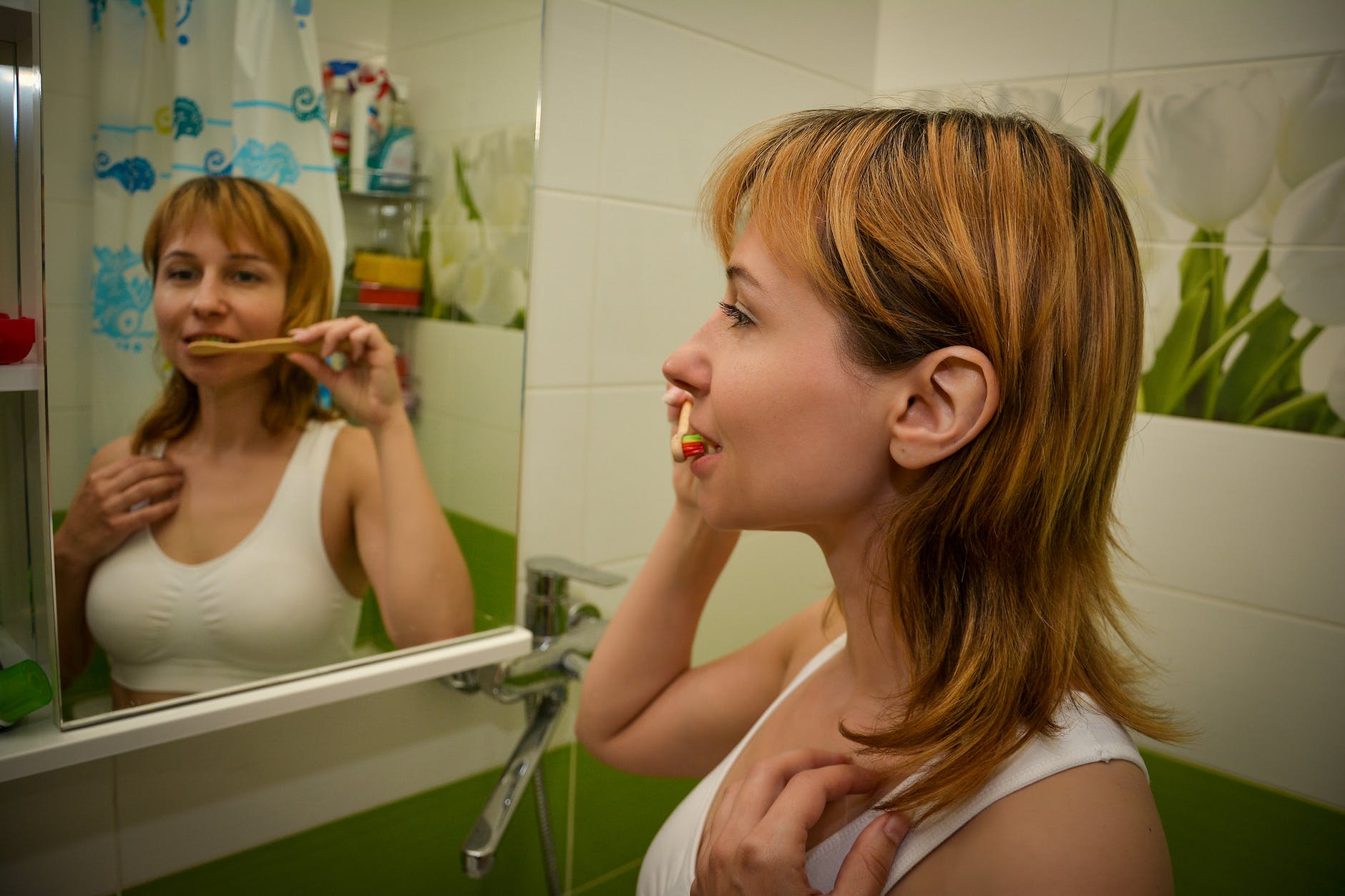 young pretty redhead brushing teeth