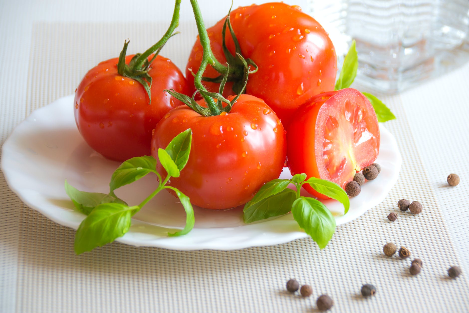 tomato top of white ceramic plate