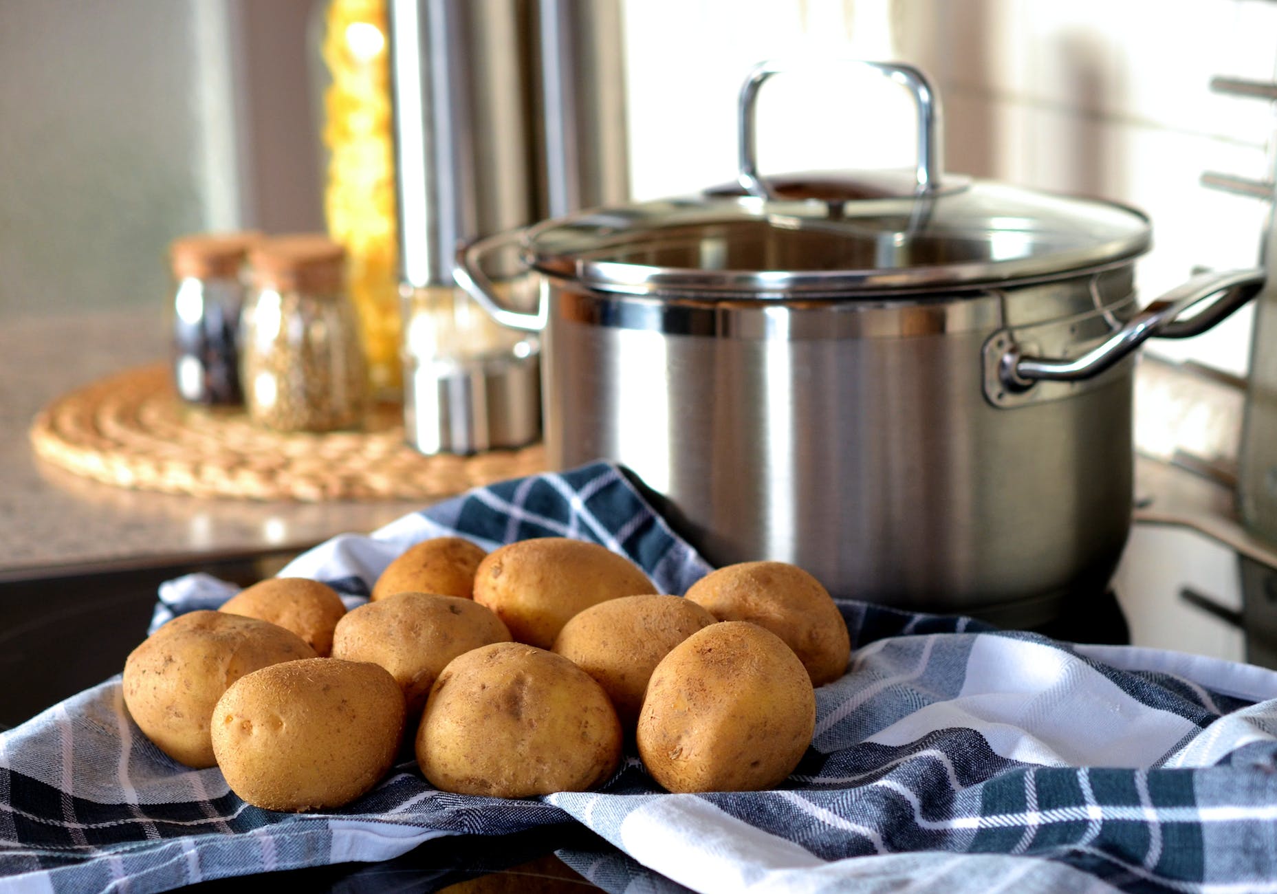 potatoes beside stainless steel cooking pot