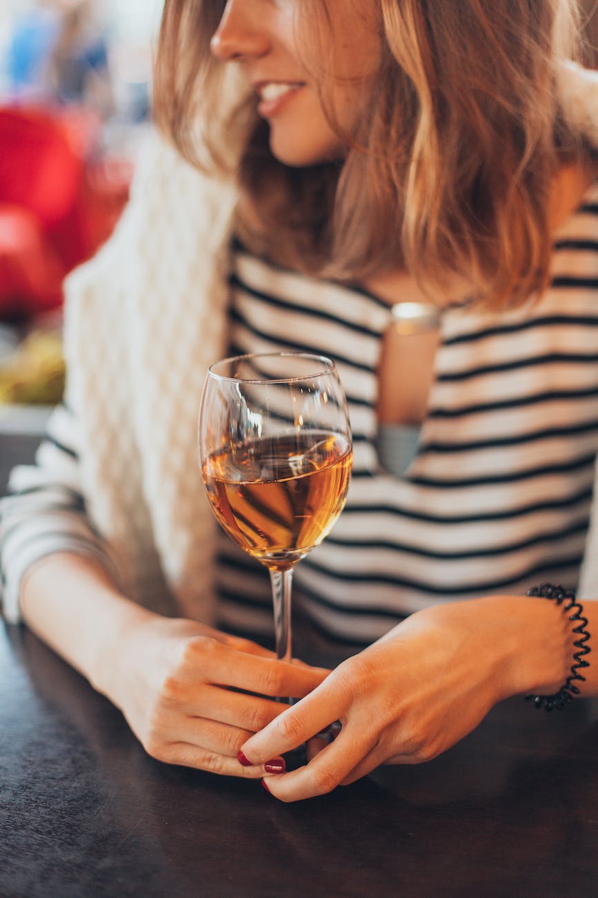 woman holding glass of wine