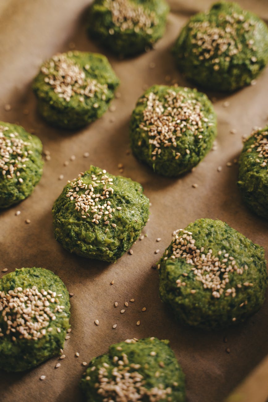 close up photograph of falafels with sesame seeds