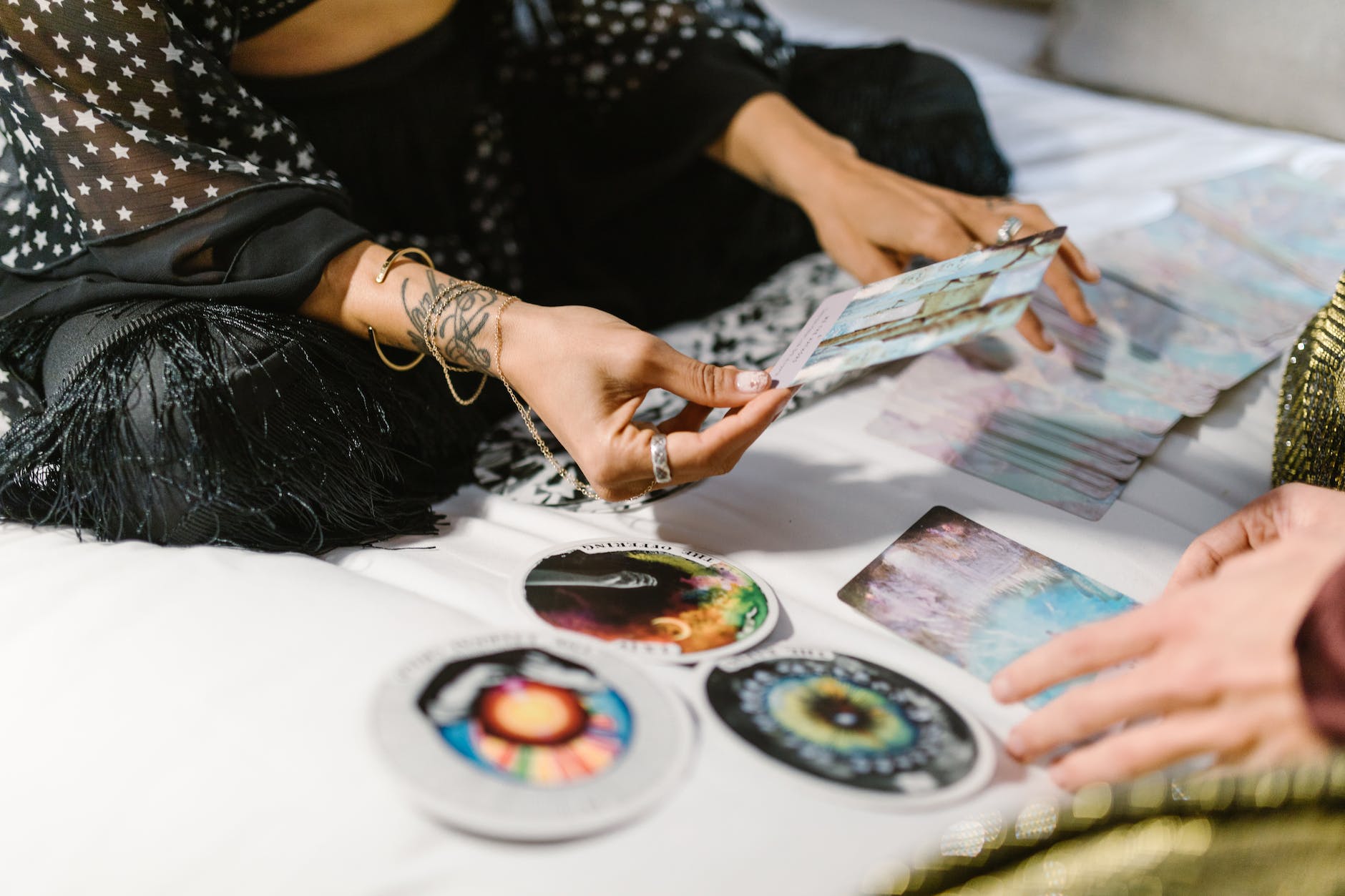 woman sitting on a bed holding a card