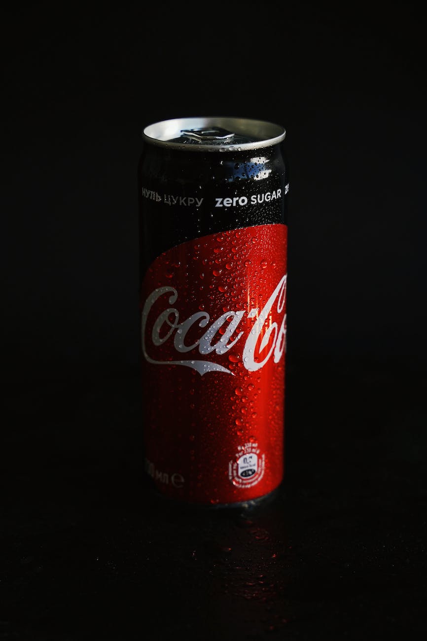 coca cola can on black surface