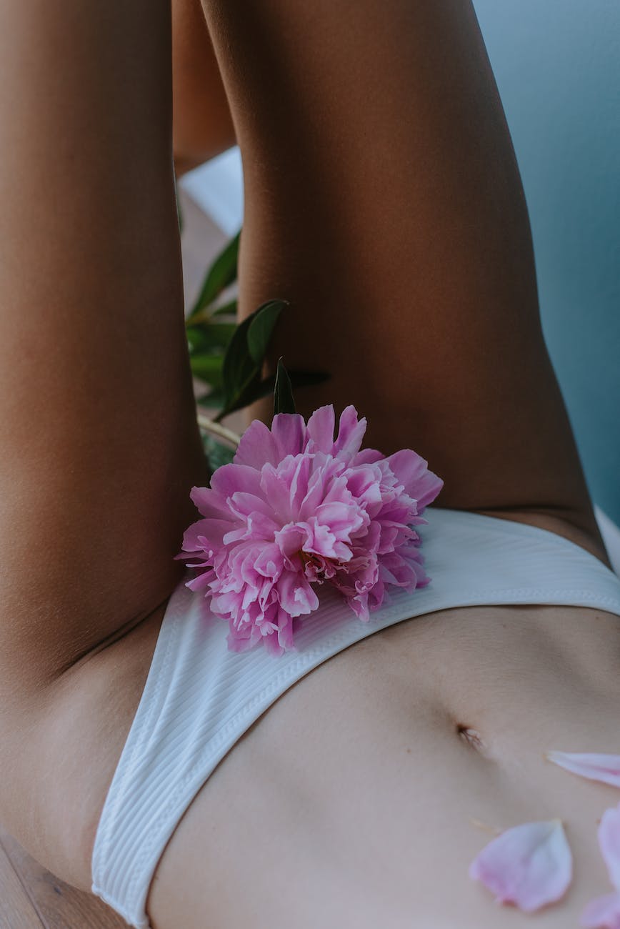 a pink flower and a woman